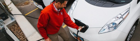 Man in University of Utah fleece charges his electric vehicle.